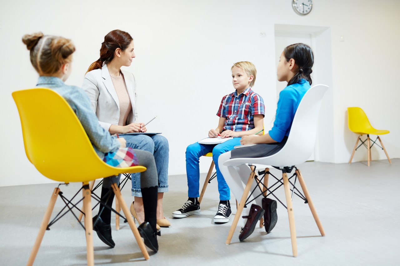 Elementary school learners answering questions of teacher or sharing opinions at seminar