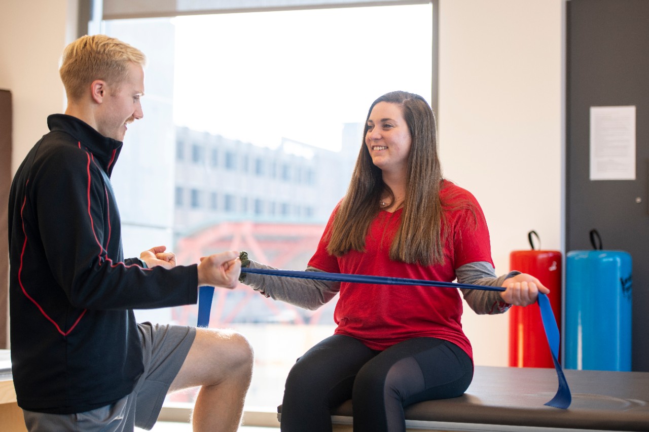 Garret Phipps, Austin Jarosz and Madison Taber, PT students, working together in classroom.