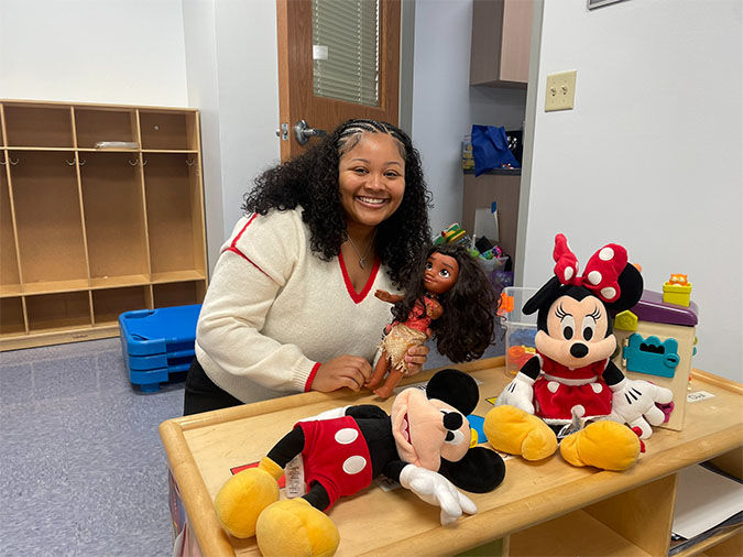 Student in child care room around toys