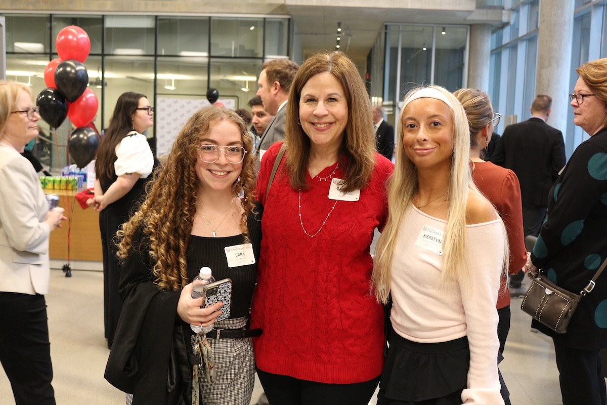 Students posing with donor at a reception