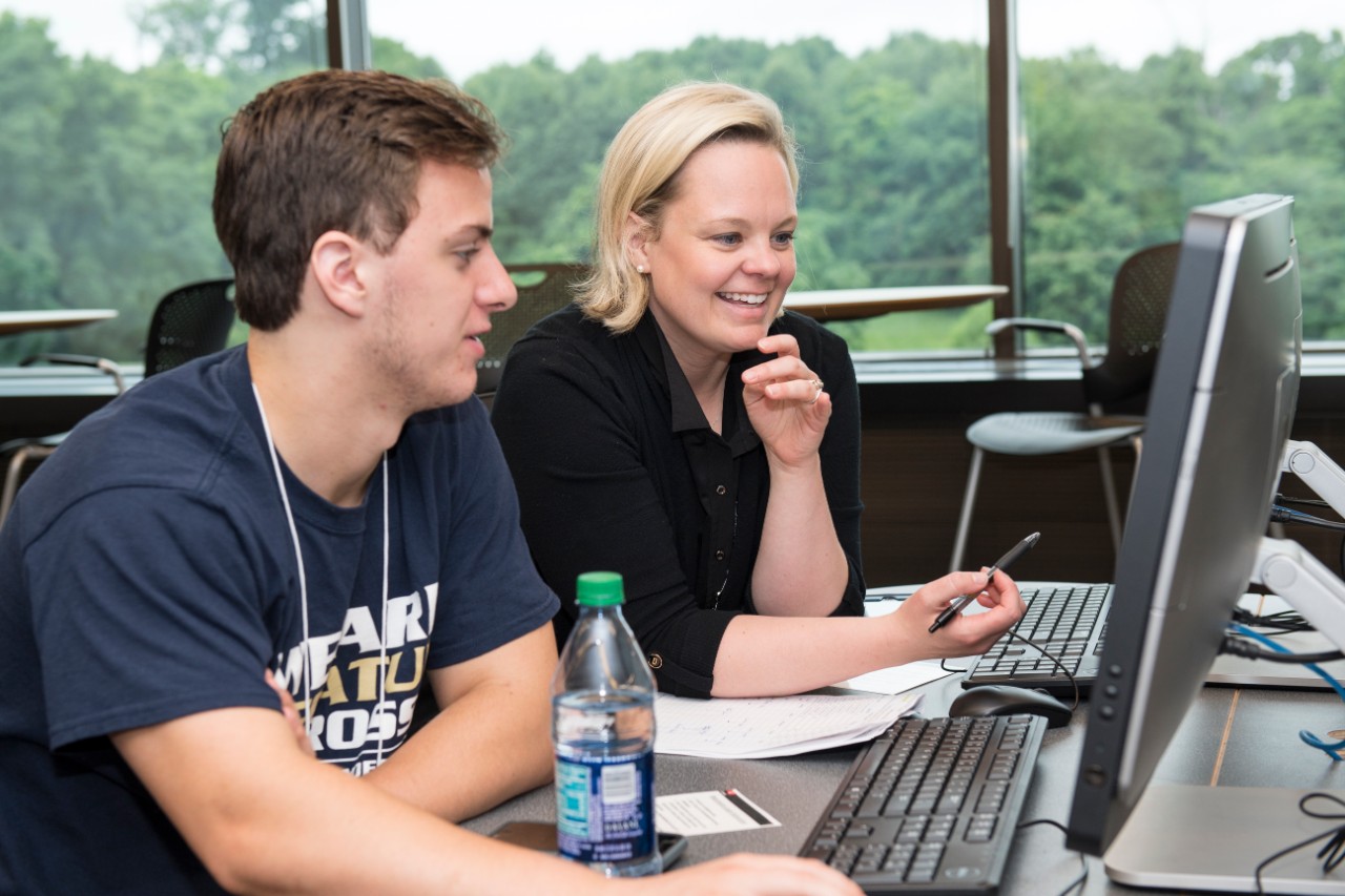 CAHS Advisors working with incoming students in Langsam Library.